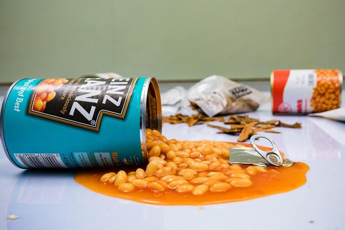 Visual of spilled canned beans, depicting an accidental situation where beans have spilled