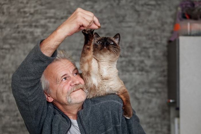 cat on man's shoulder