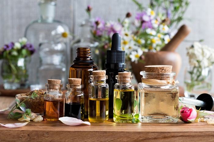 Vibrantly colored essential oil bottles neatly arranged, creating a visually captivating composition that appeals to the senses