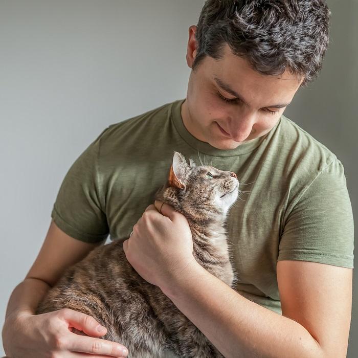Man hugging his cat