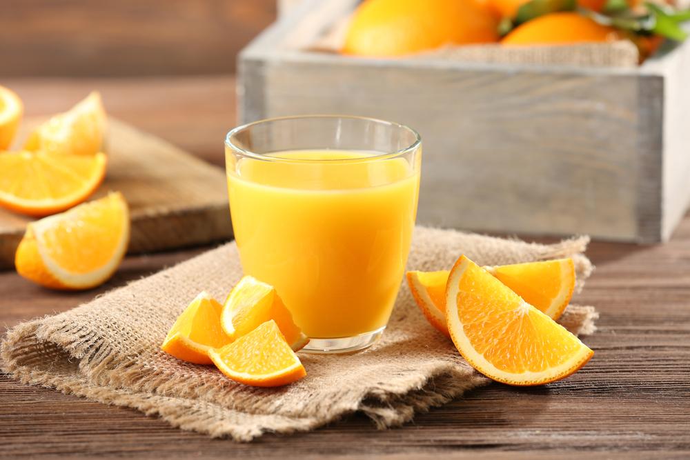Glass of orange juice placed on a table