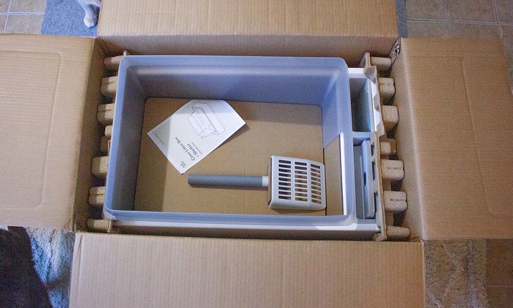 A litter box in its original shipping box and materials.