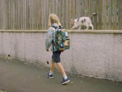kiki Walks a Boy to School Daily